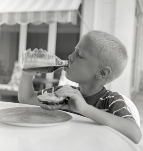 Boy Drinking Juice from Bottle While Holding Sandwich Stretched Canvas - (24 X 36)