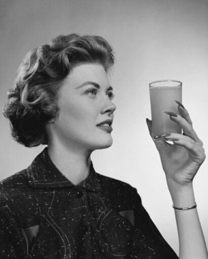 Close-up of a Young Woman Holding a Glass of Juice Stretched Canvas - (24 X 36)